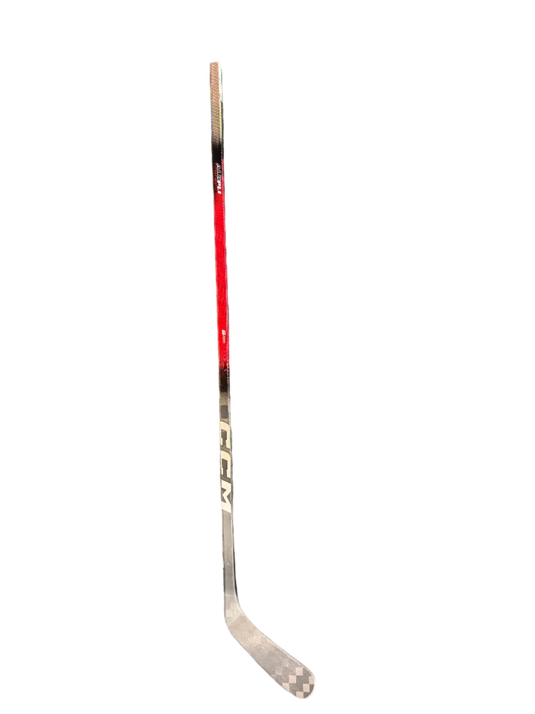 Hockey stick with CCM branding on a gray surface