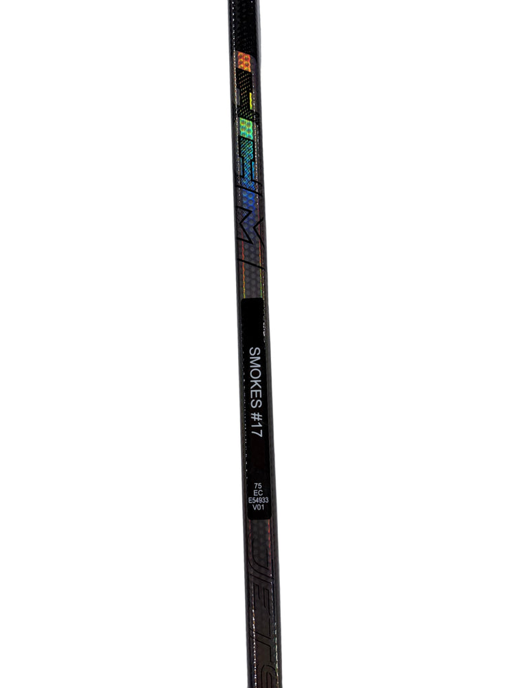 Hockey stick with branding on a textured gray surface